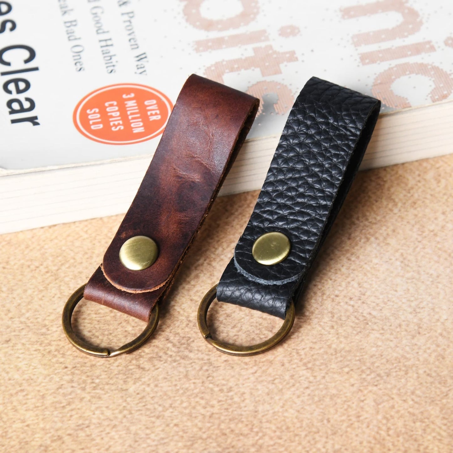 Handmade leather keychain strap in brown and black on belt and bag